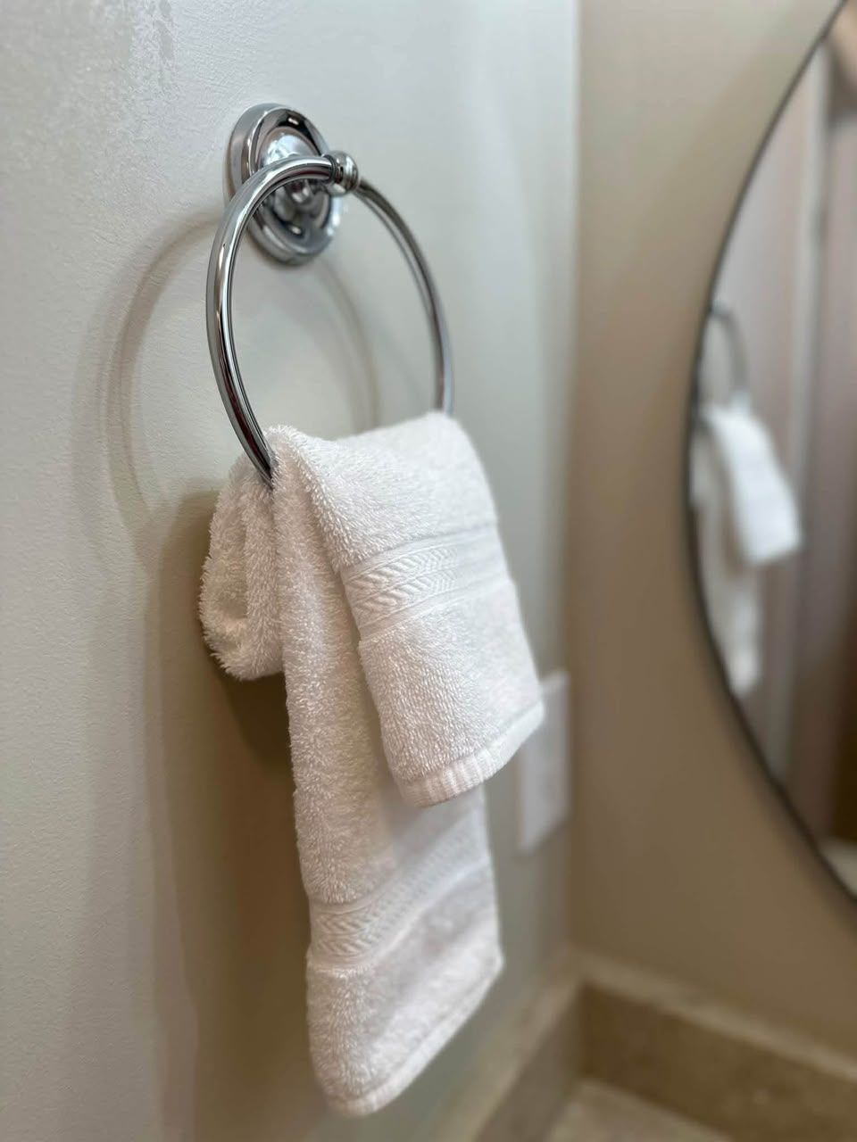 Fresh towel neatly hung in a clean bathroom